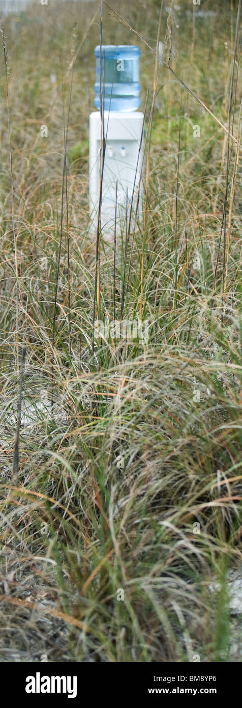 Water cooler in field of dry grass Stock Photo
