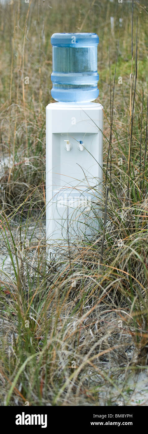 Water cooler in field of dry grass Stock Photo
