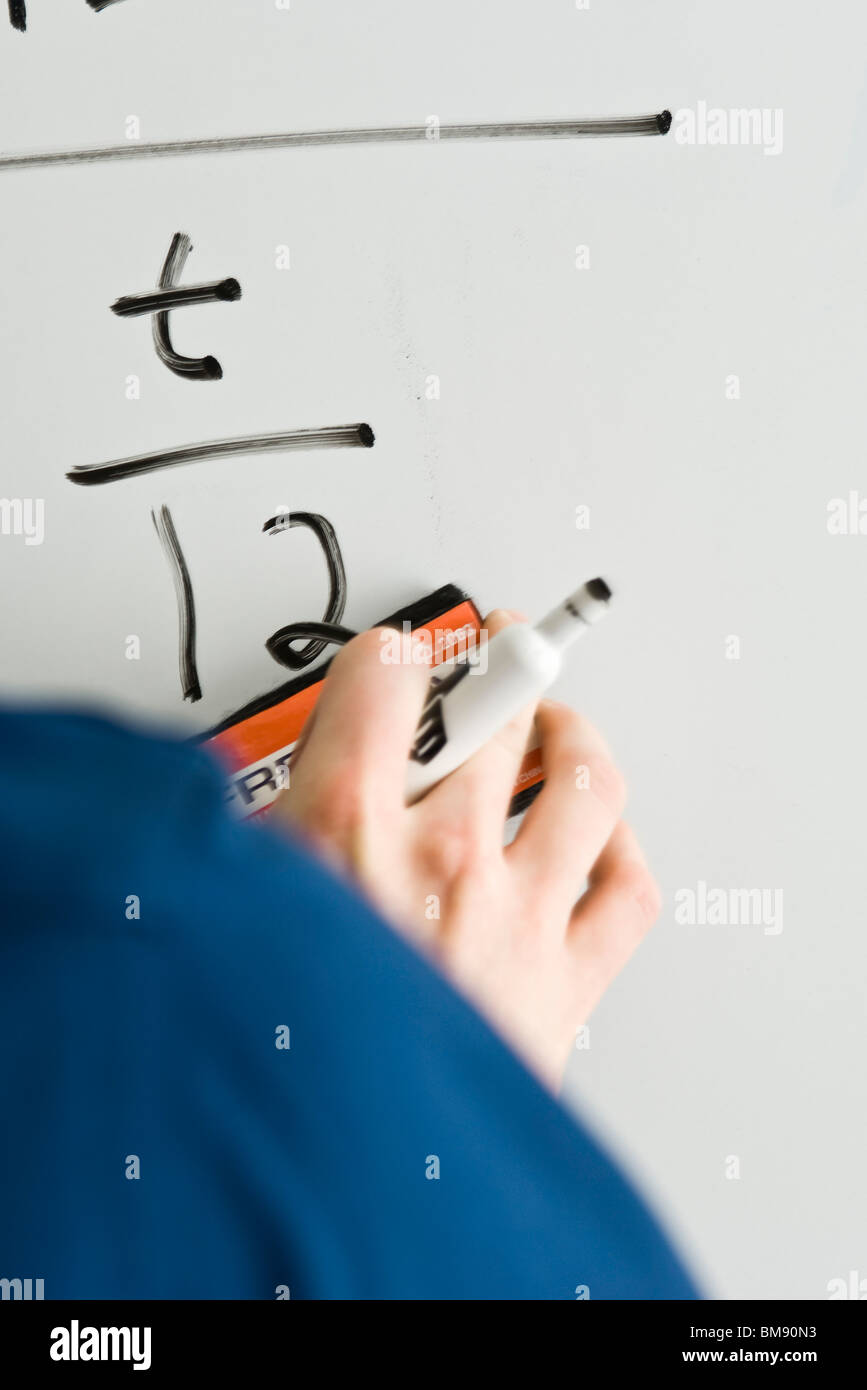 Writing equation on whiteboard Stock Photo