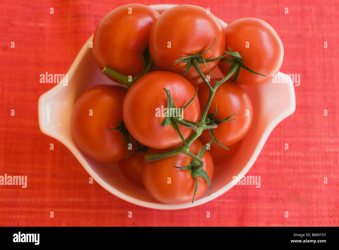 Ripe vine tomatoes in bowl Stock Photo