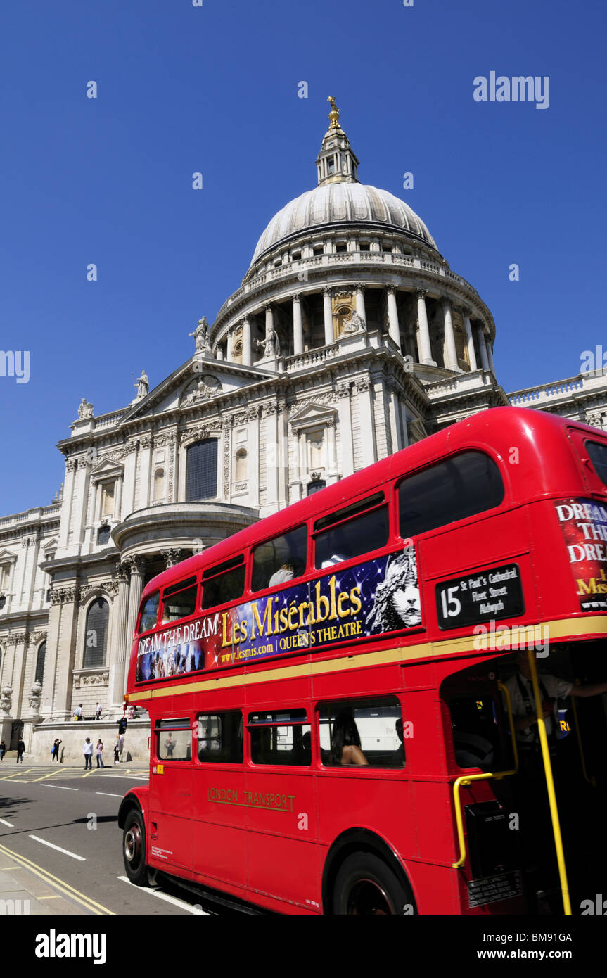 An old iconic Routemaster double decker bus with Les Miserables advert passing St Pauls Cathedral, London, England, UK Stock Photo