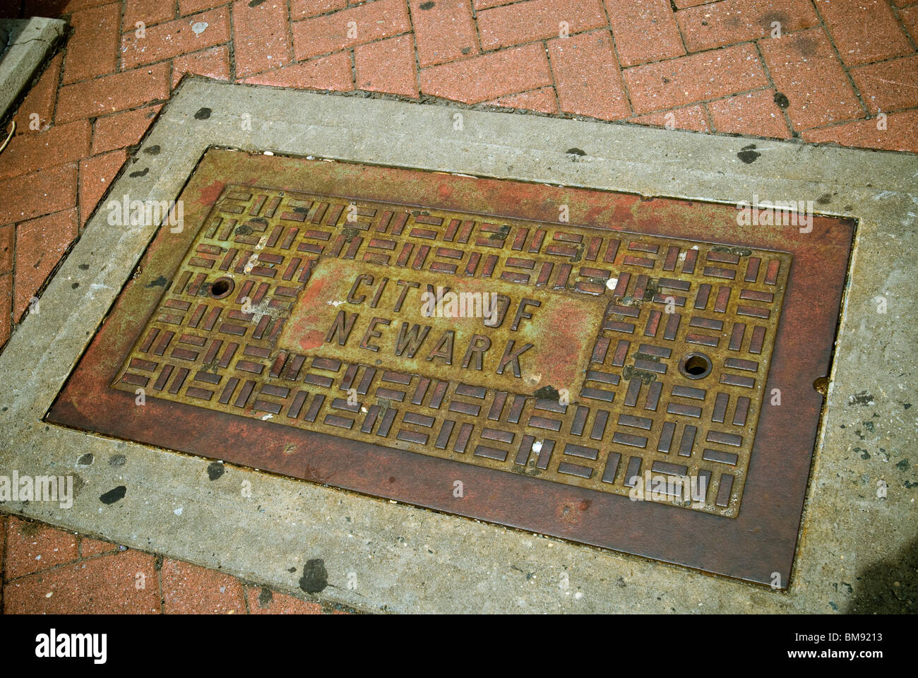 An access port for underground infrastructure is seen on the street in Newark, NJ on Saturday, May 22, 2010. Stock Photo