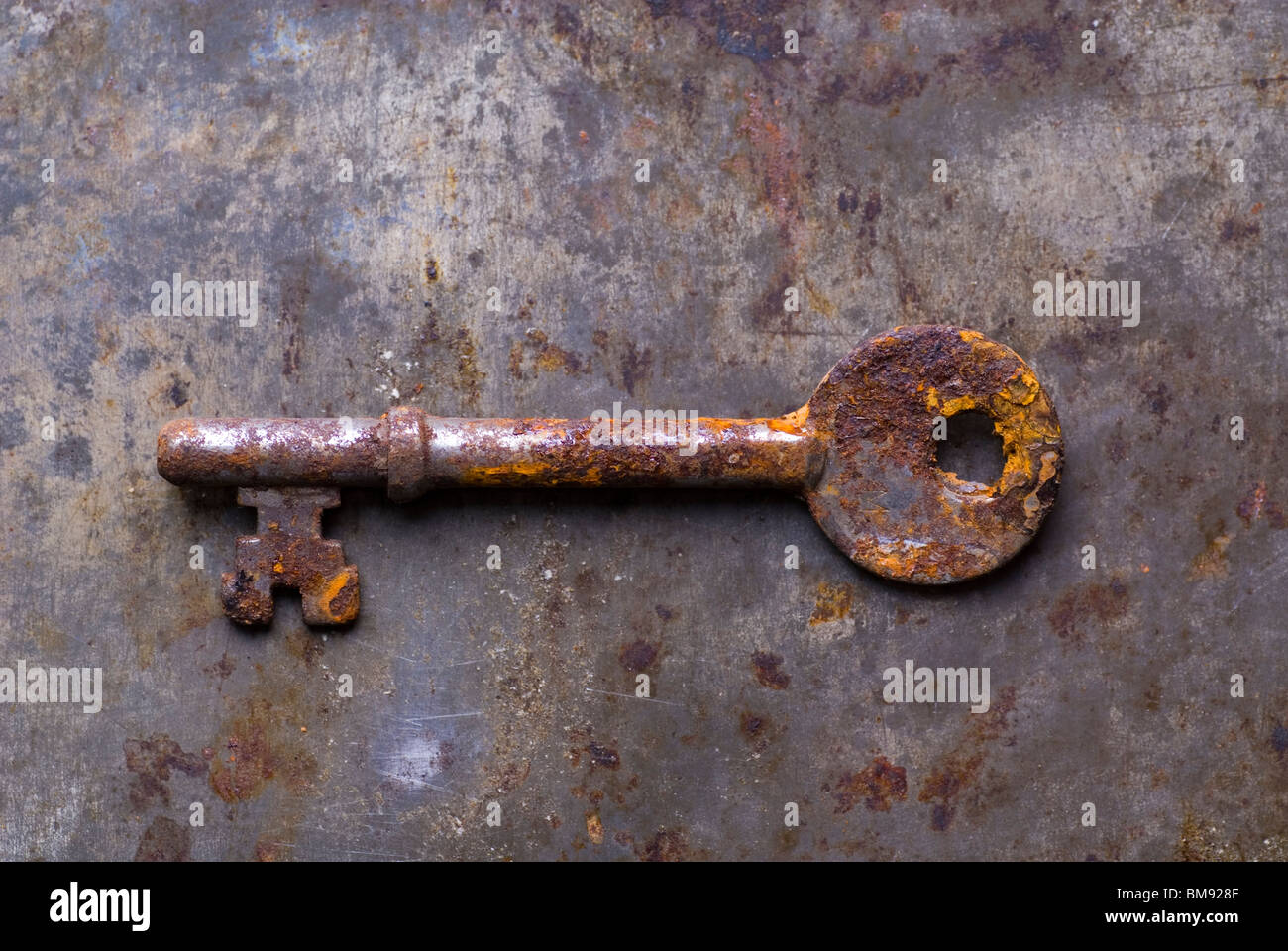 Dirty old rusted house key over a grunge background Stock Photo Alamy