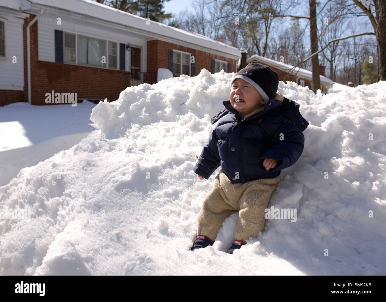 Asian baby boy sitting on snow Stock Photo