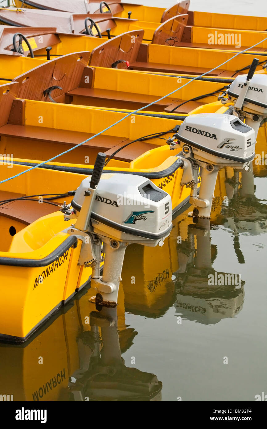 Small hire motor boats moored in the early morning on the River Thames at Windsor, Berkshire, Uk