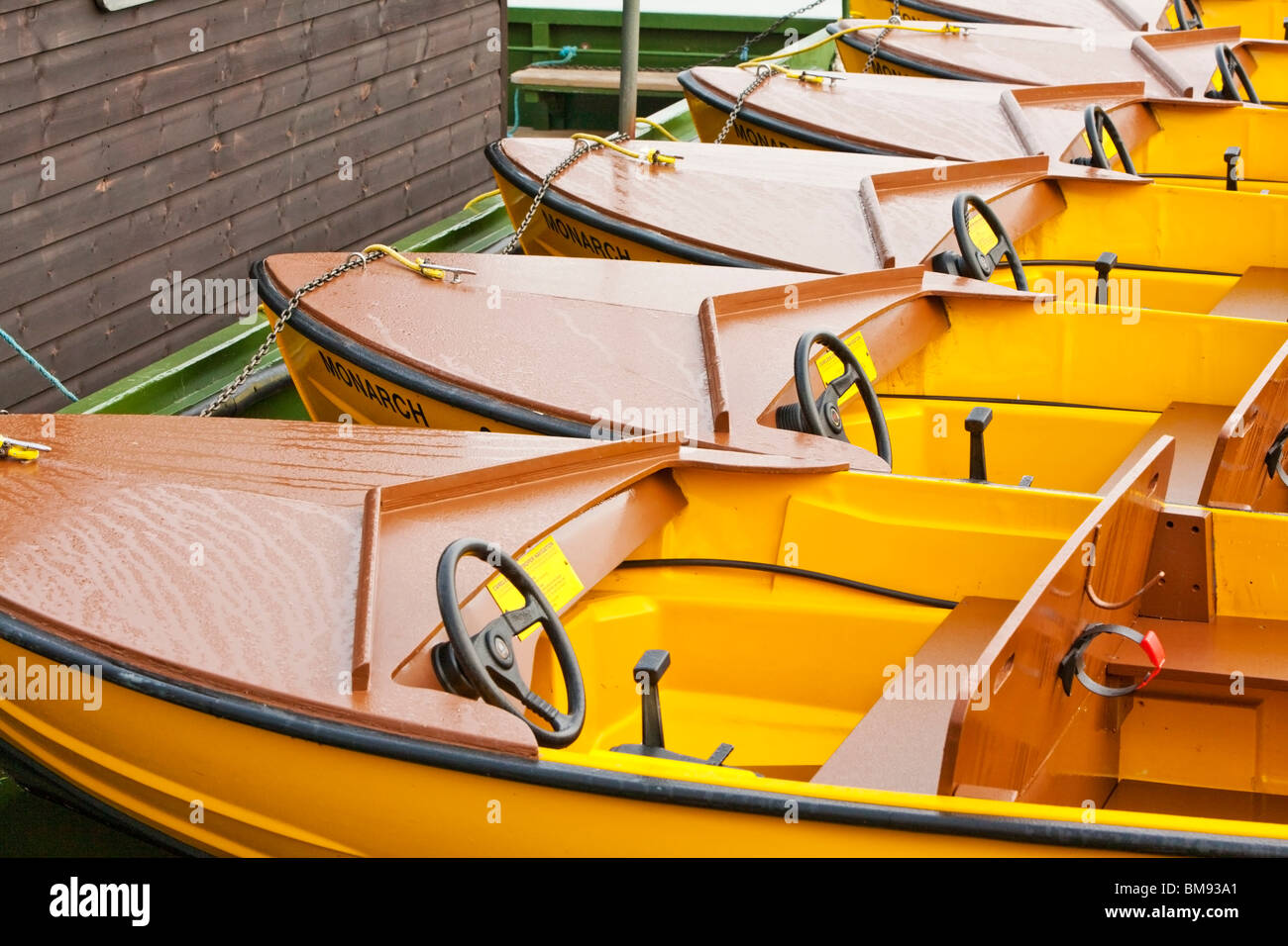 Small hire motor boats moored in the early morning on the River Thames at Windsor, Berkshire, Uk