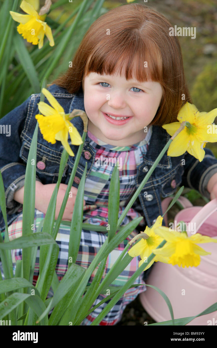 Little Girl With Daffodils Stock Photo Alamy