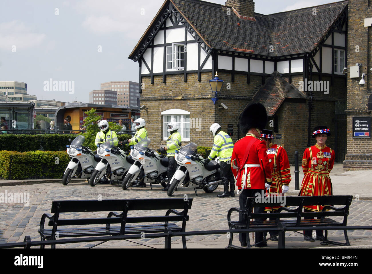 Metropolitan Police Special Escort Group motorcycle outriders, Beefeaters and officer wearing Bearskin hat at Tower of London. Stock Photo