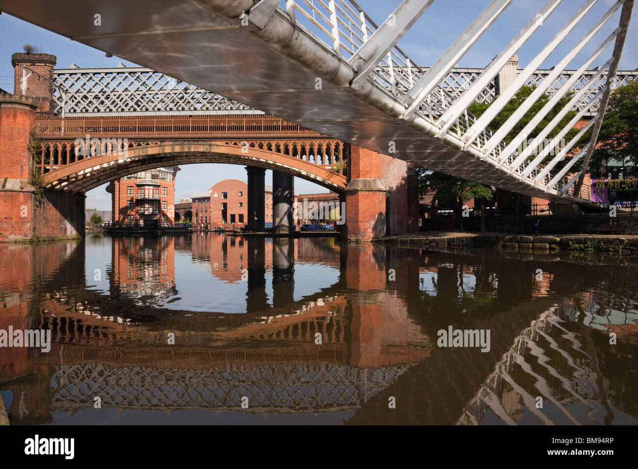 Merchant's Bridge and old railway bridge over Bridgewater Canal basin in Castlefield Urban Heritage Park conservation area. Manchester England UK Stock Photo