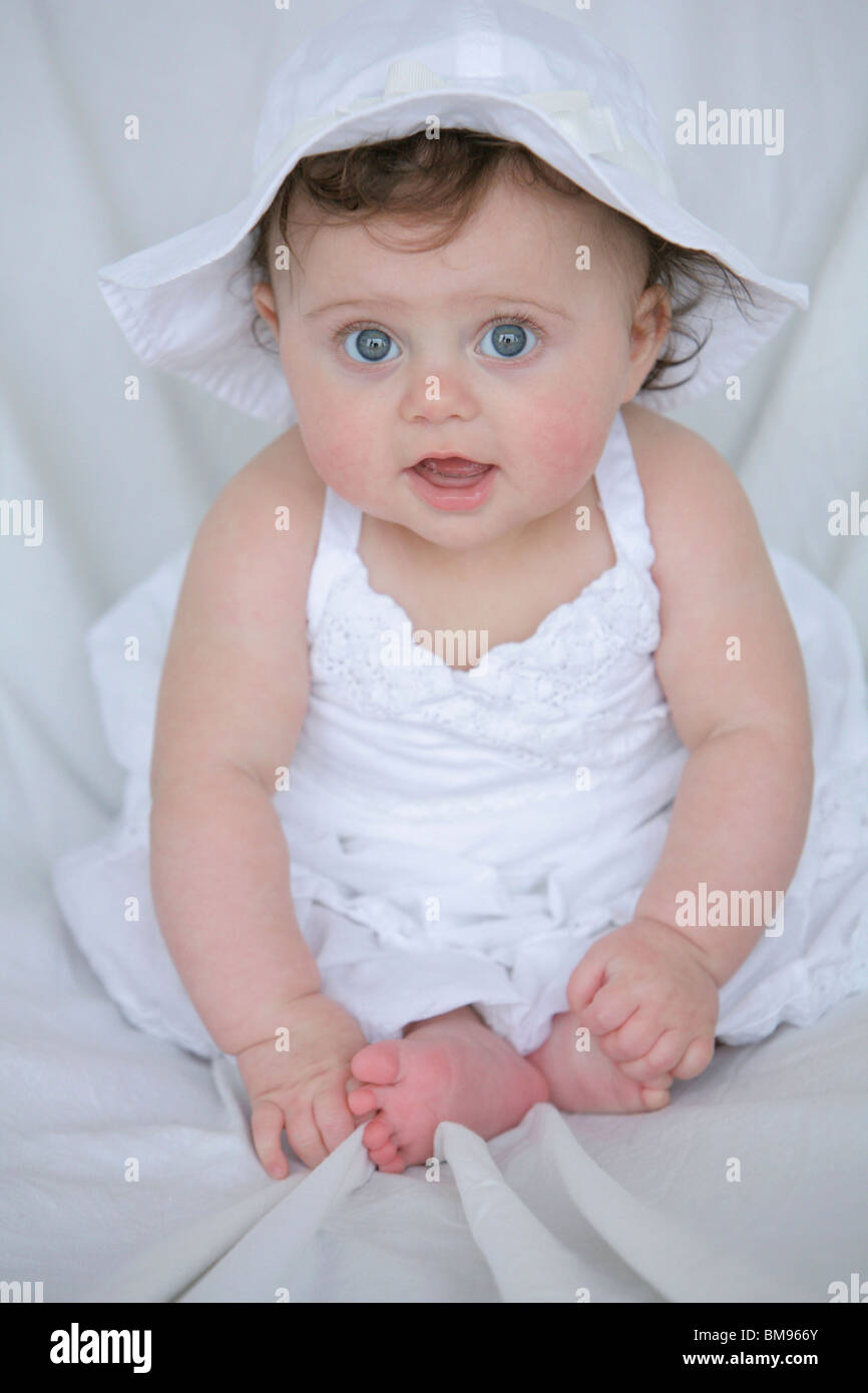 Baby Girl In White Dress And Hat Stock Photo Alamy