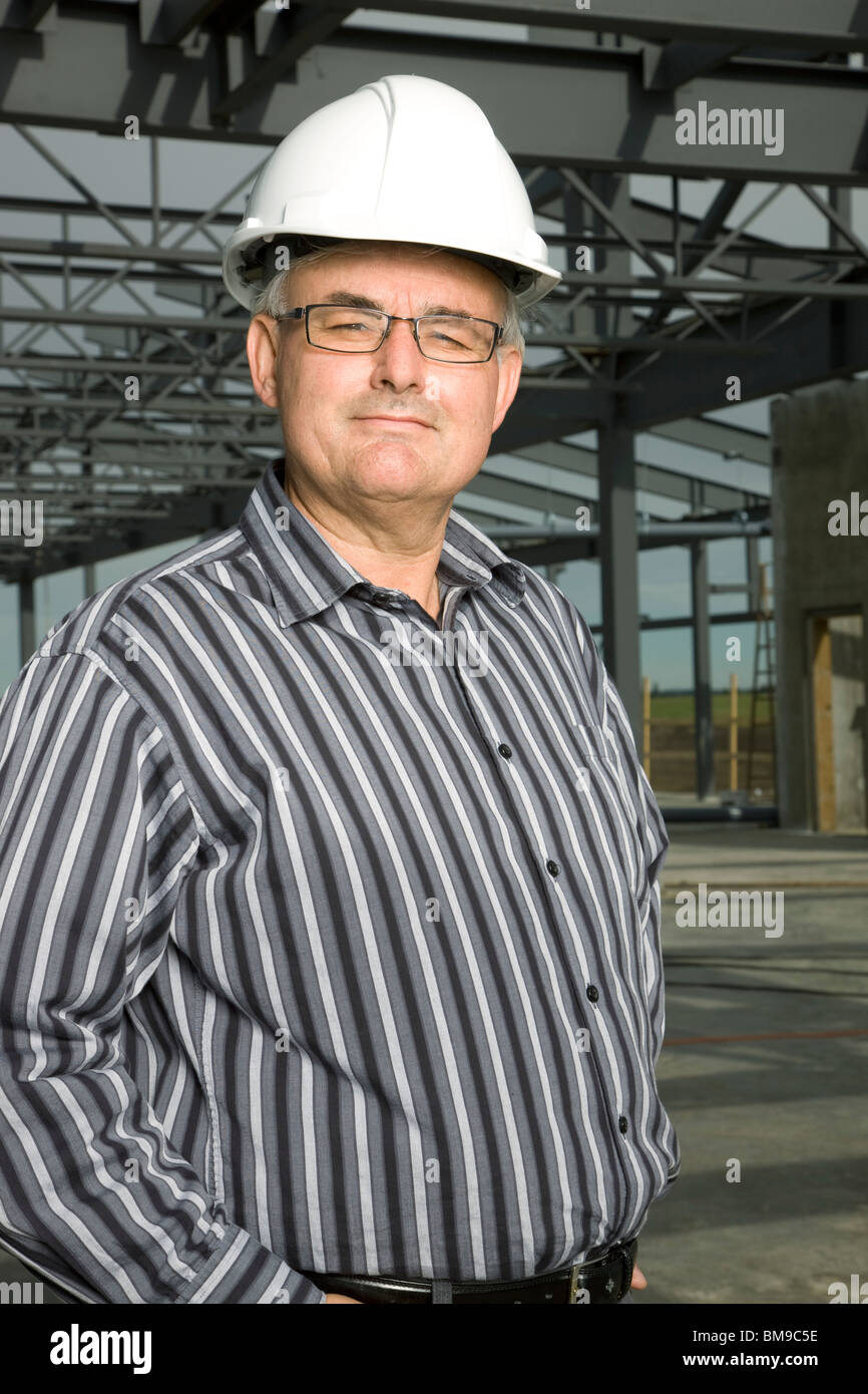 Man In Hardhat In Partially Built Building Stock Photo