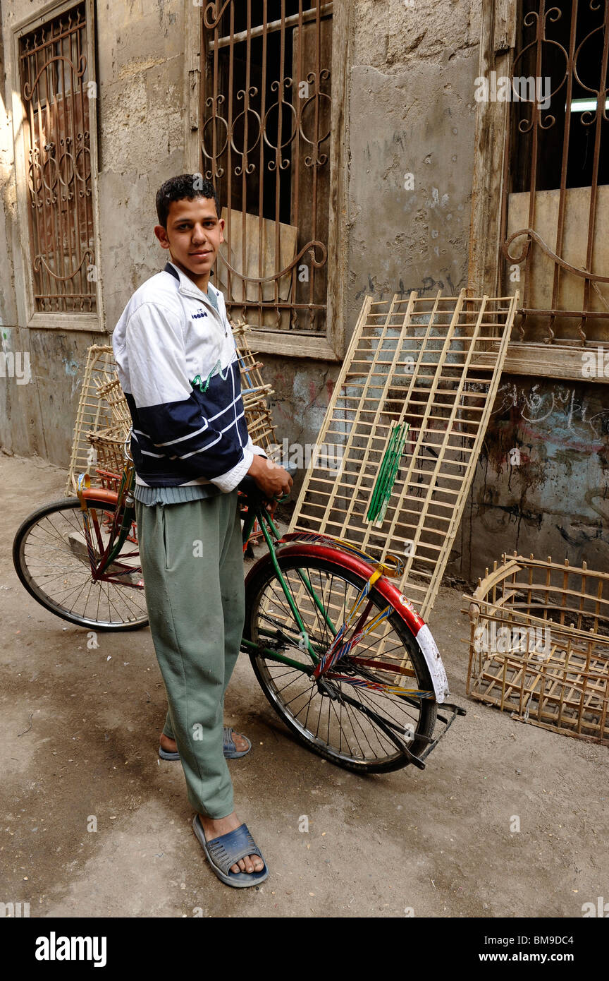 bread delivery boy posing with his bicycle , back streets of islamic cairo , egypt Stock Photo