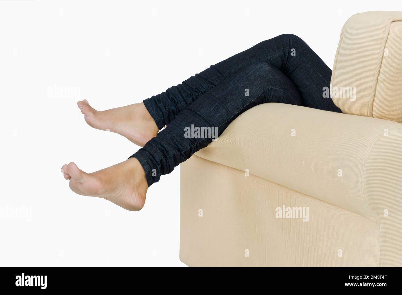 Low section view of a woman lying on a couch Stock Photo - Alamy