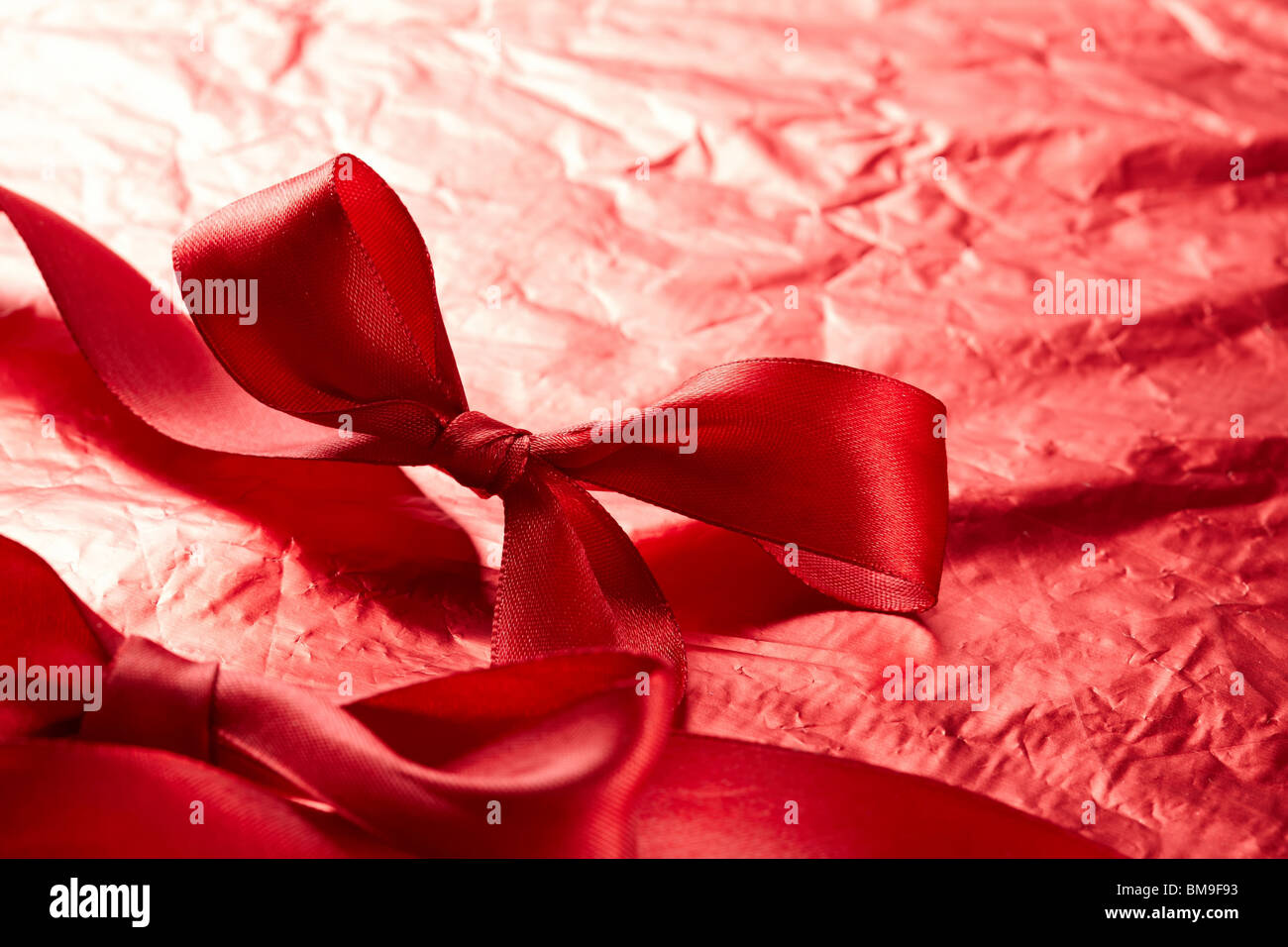 satin ribbons on the red background Stock Photo - Alamy