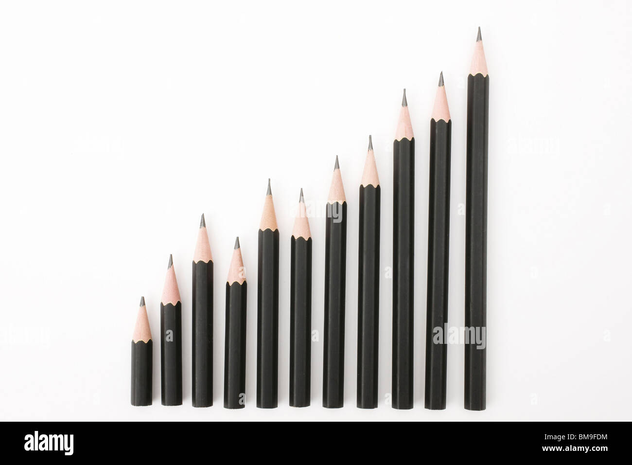 Pencils in increasing height order, white background Stock Photo