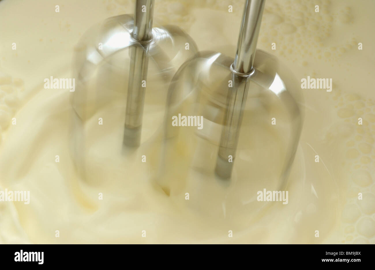 Mixer whipping cream, close up, blurred motion Stock Photo Alamy