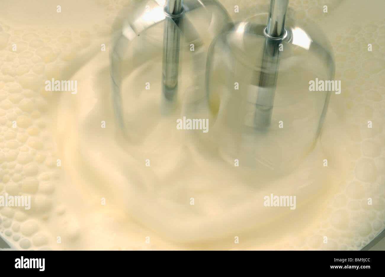 Mixer whipping cream, close up, blurred motion Stock Photo Alamy