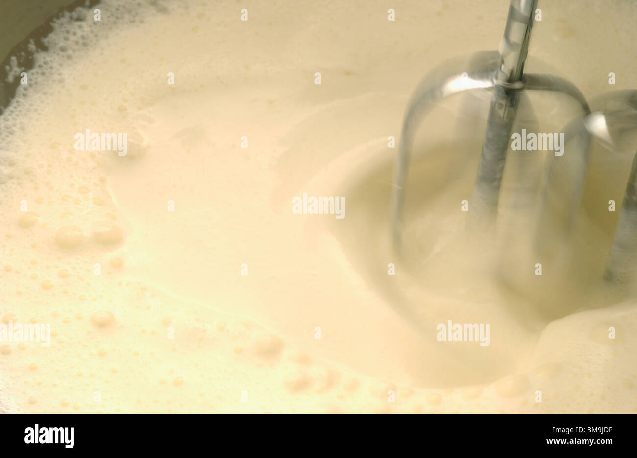 Mixer whipping cream, close up, blurred motion Stock Photo Alamy
