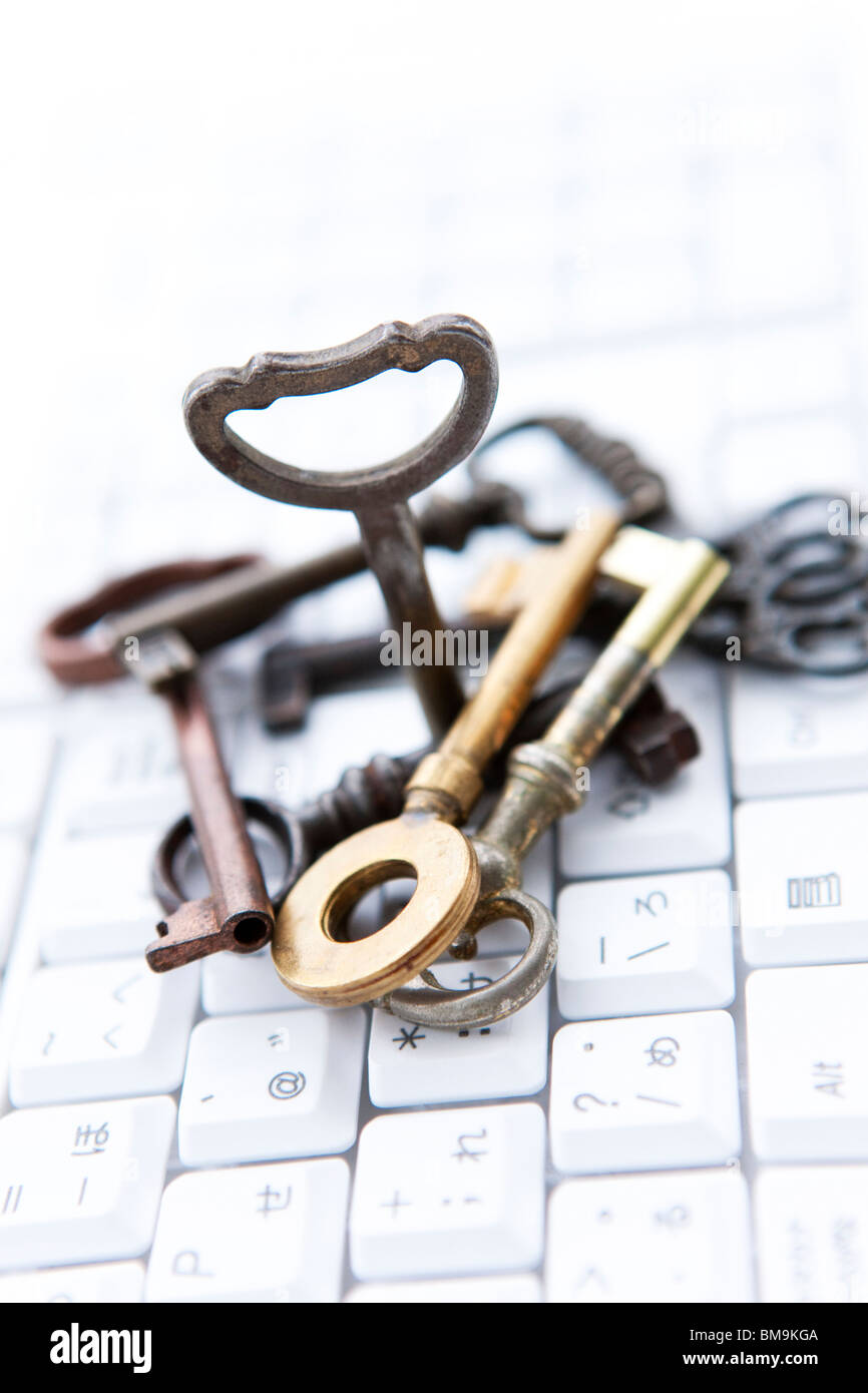 Stack of keys on computer keyboard, close up Stock Photo - Alamy