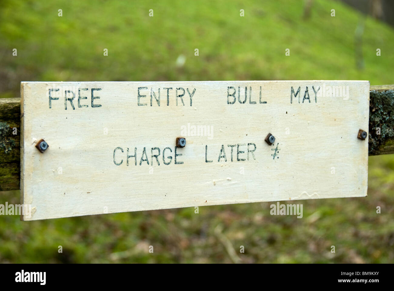 Sign on a gate near Stainforth in Ribblesdale, Yorkshire Dales National Park, England, UK. 'Free entry, bull may charge later' Stock Photo
