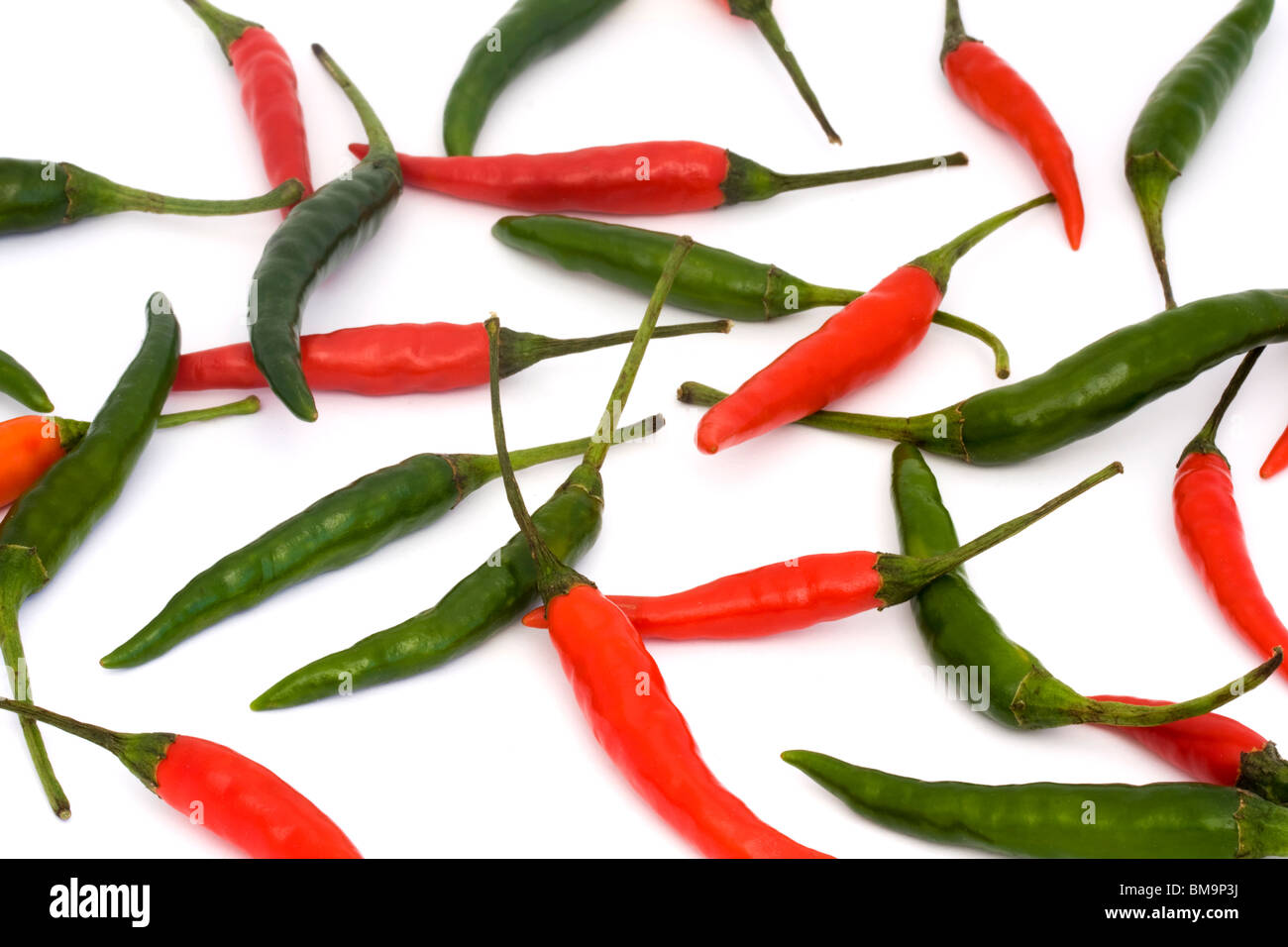 background of red and green chillies on a white background Stock Photo