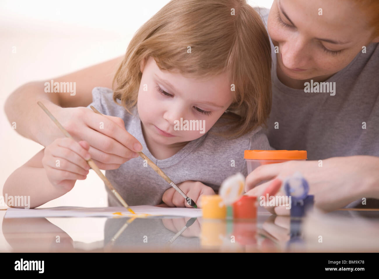 mother and saughter painting together Stock Photo
