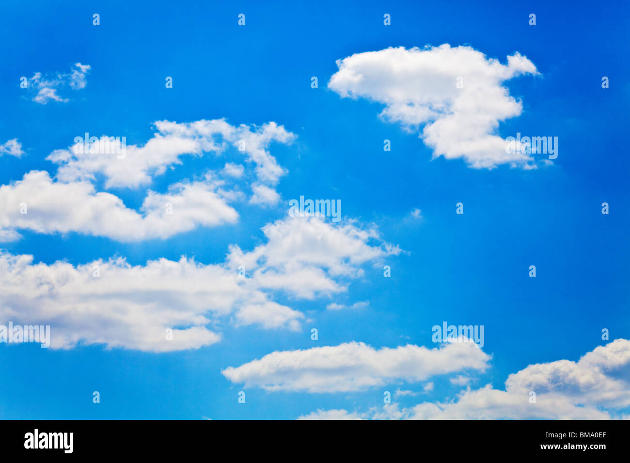 blue sky with white fluffy clouds background Stock Photo