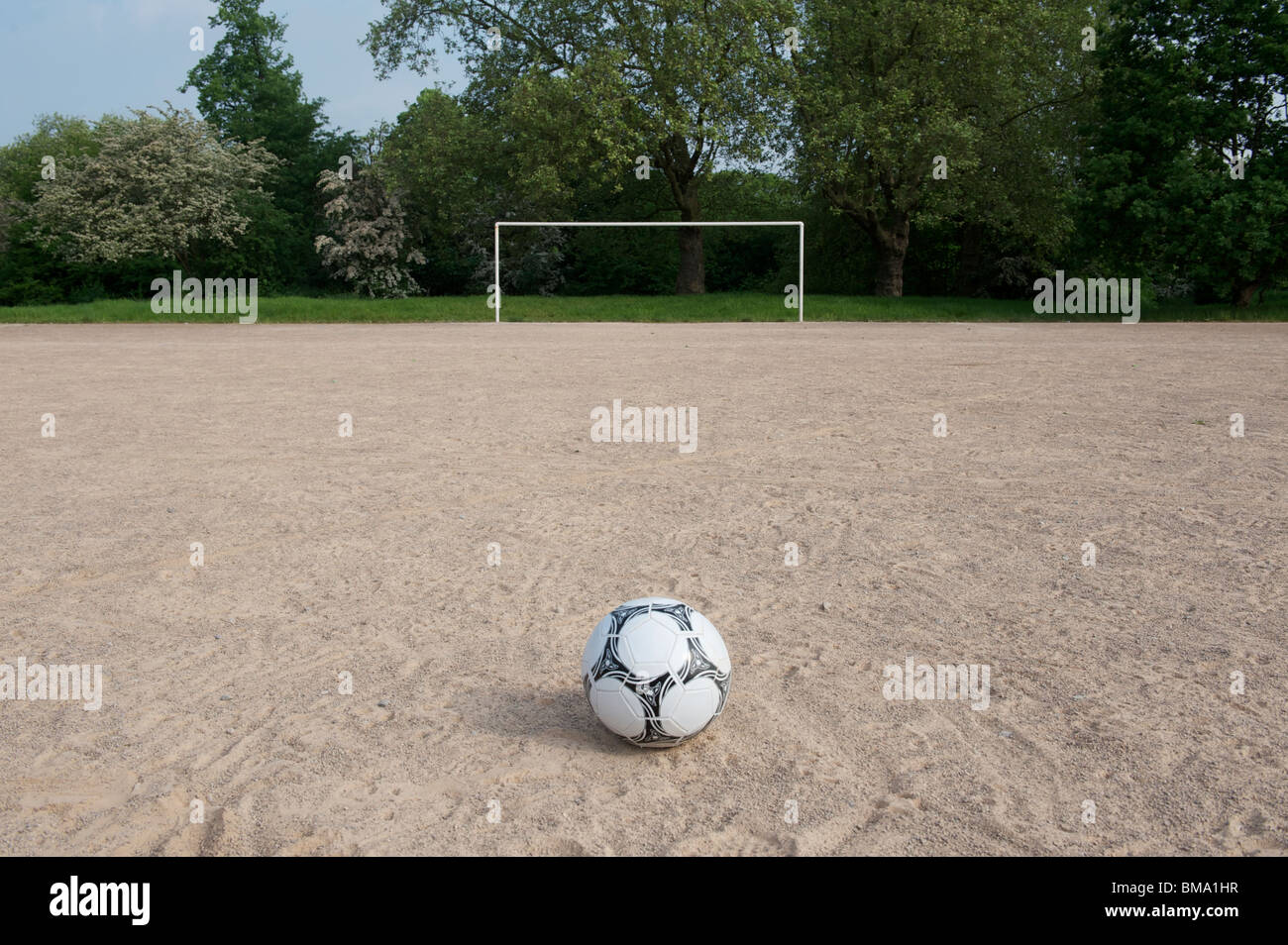 Football pitch of sand with ball and goal posts Stock Photo Alamy