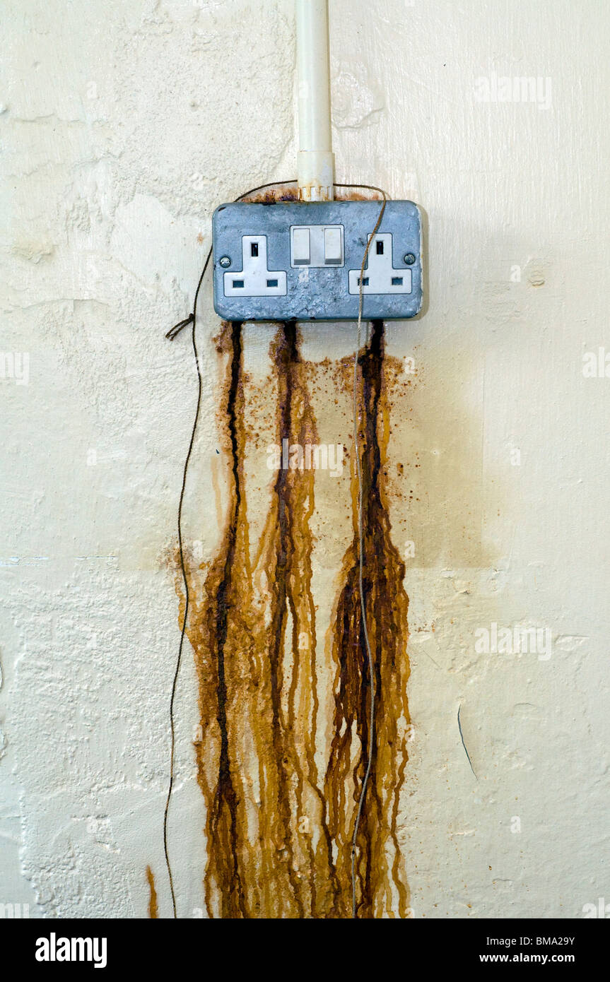 Rust seeping from electrical power point,abstract,electricity prices