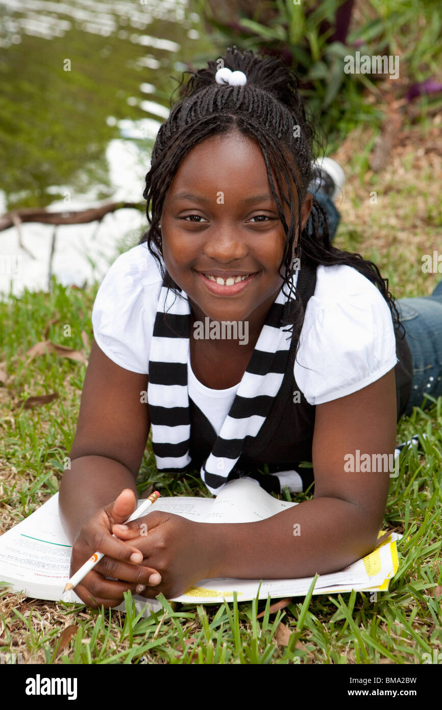 Fort Lauderdale, Florida, United States Of America; A Girl Doing School Work In The Park Stock Photo