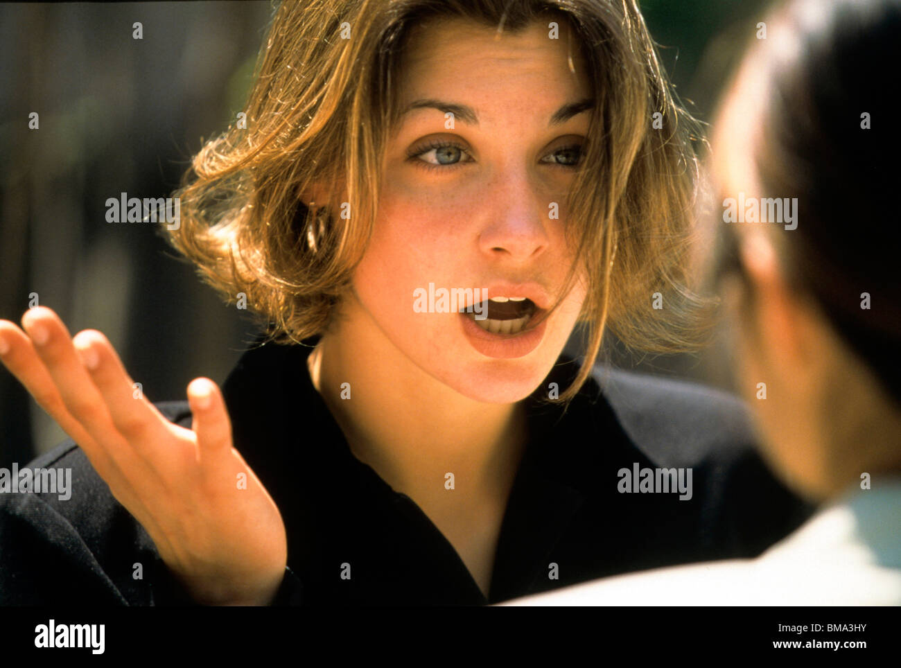 Woman gestures during conversation. Stock Photo