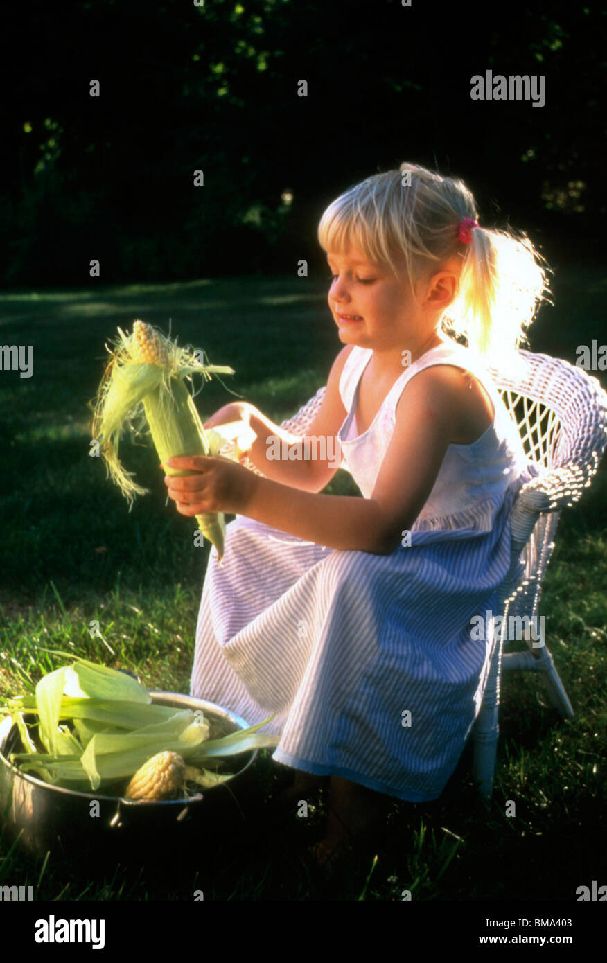 Kid shuck corn hires stock photography and images Alamy