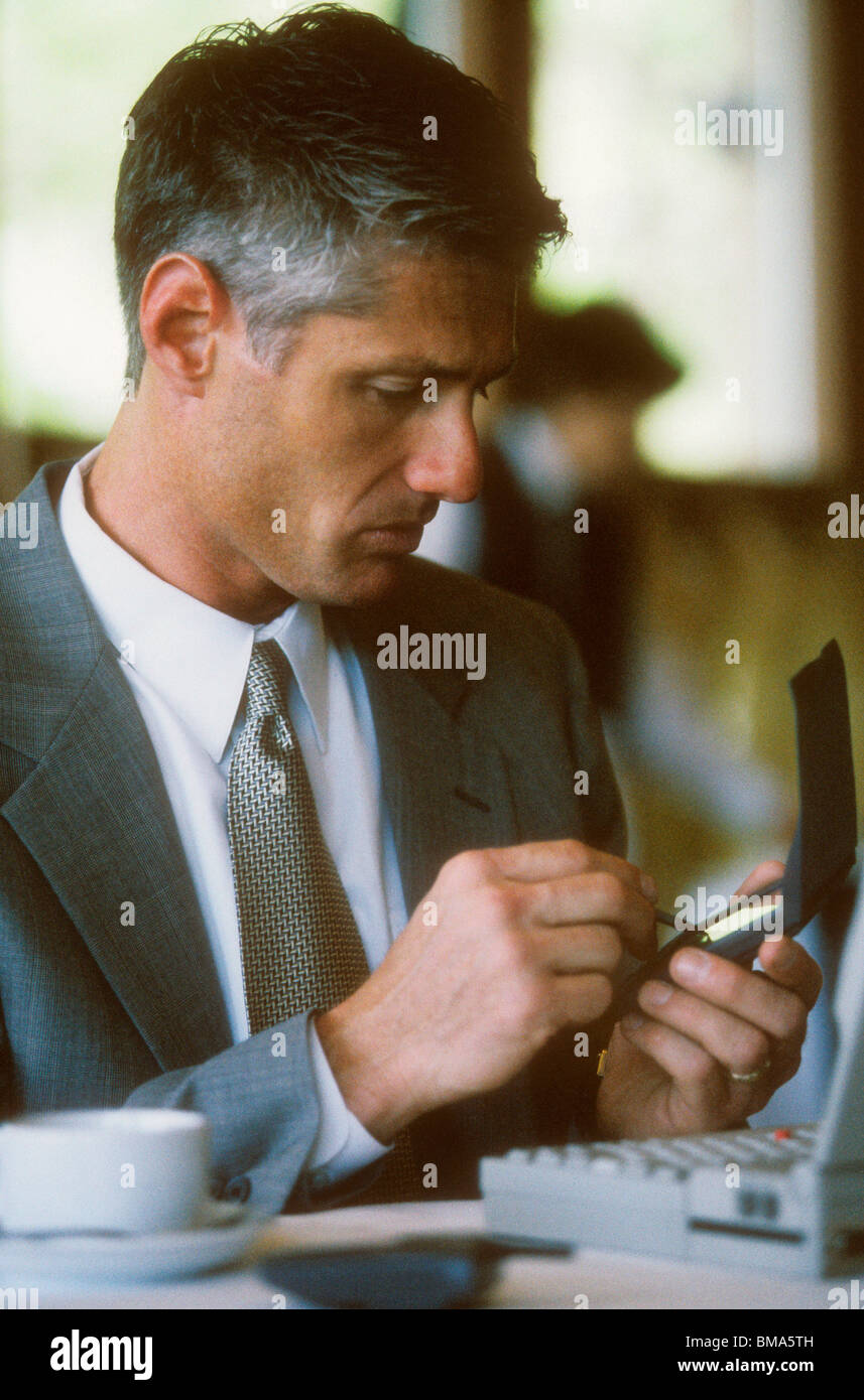 Business man using wireless mobile technology. Stock Photo