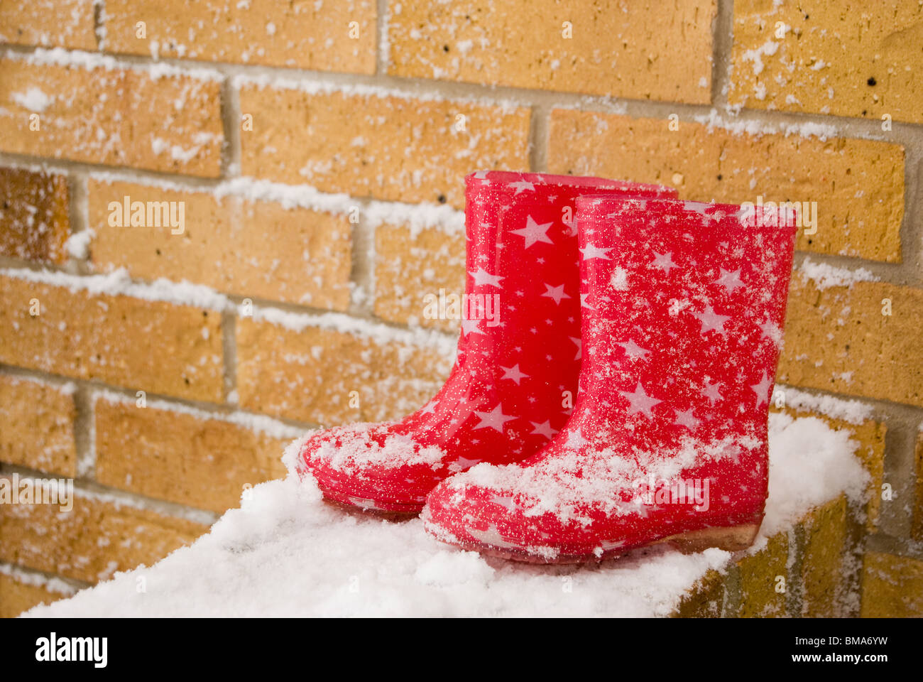 Red Wellington Boots on a Wall Stock Photo