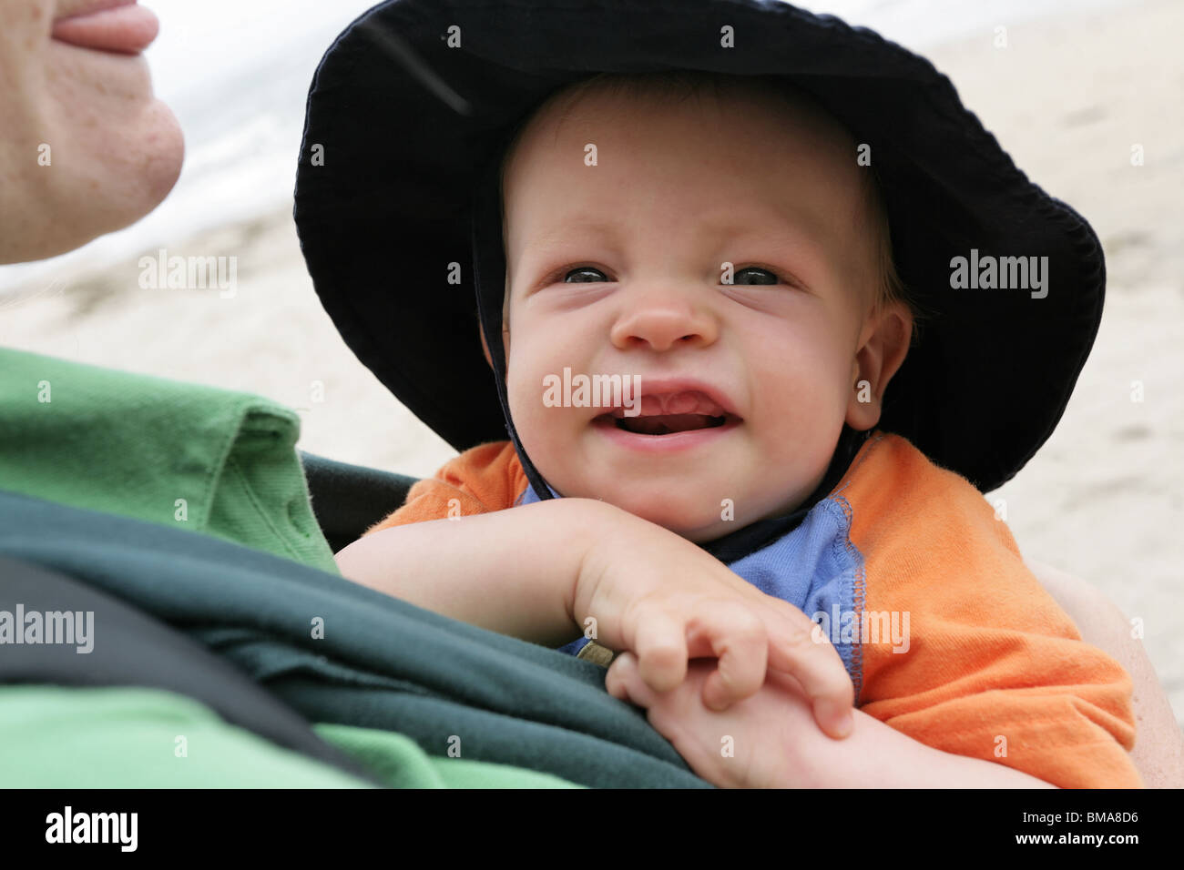 9 month old baby boy, wearing a sun hat, by the ocean Stock Photo Alamy