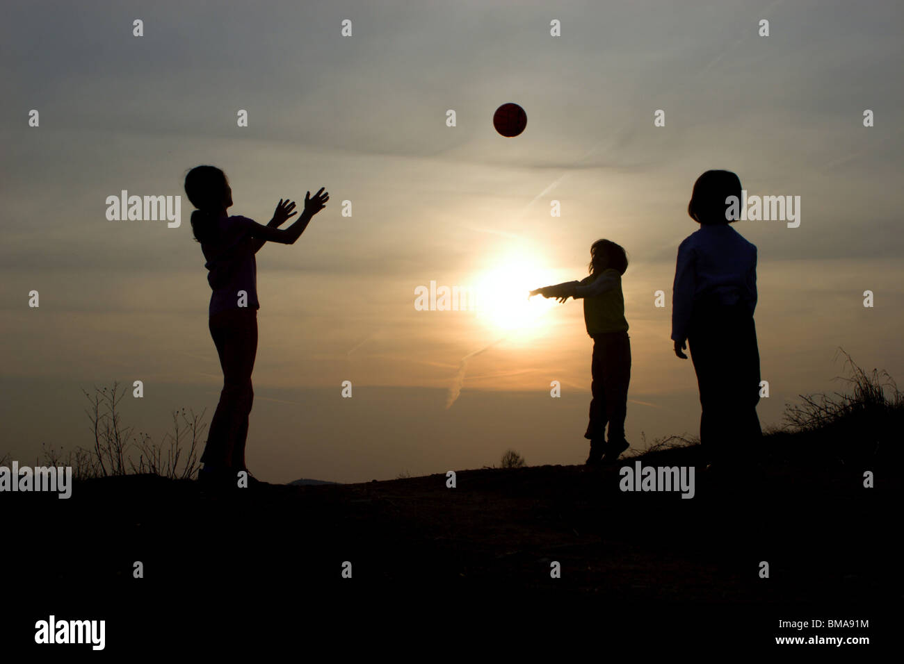 play with the ball in the sunset - silhouette Stock Photo