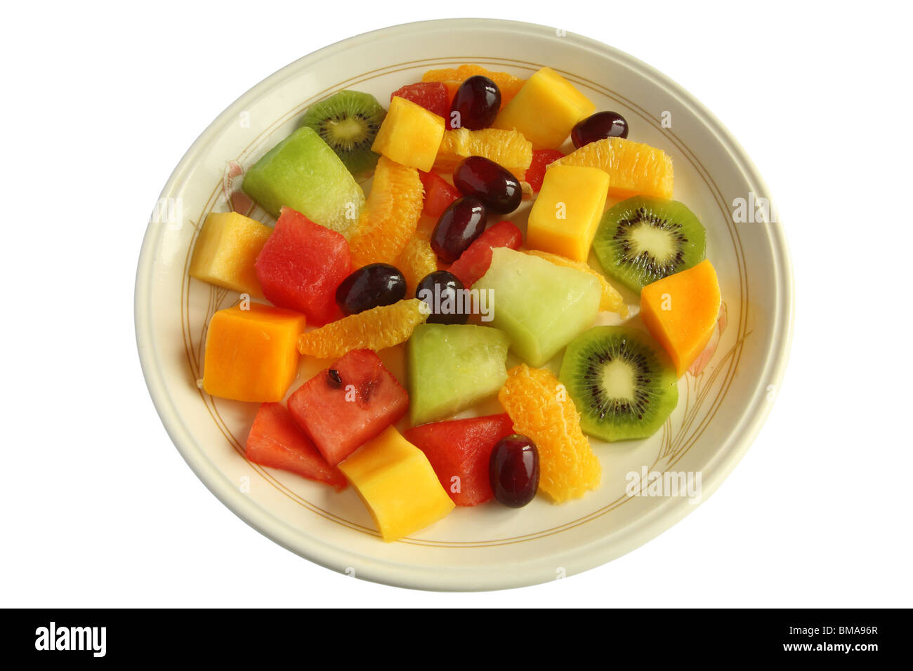 Healthy mixed fruit salad on a plate isolated over white. Stock Photo