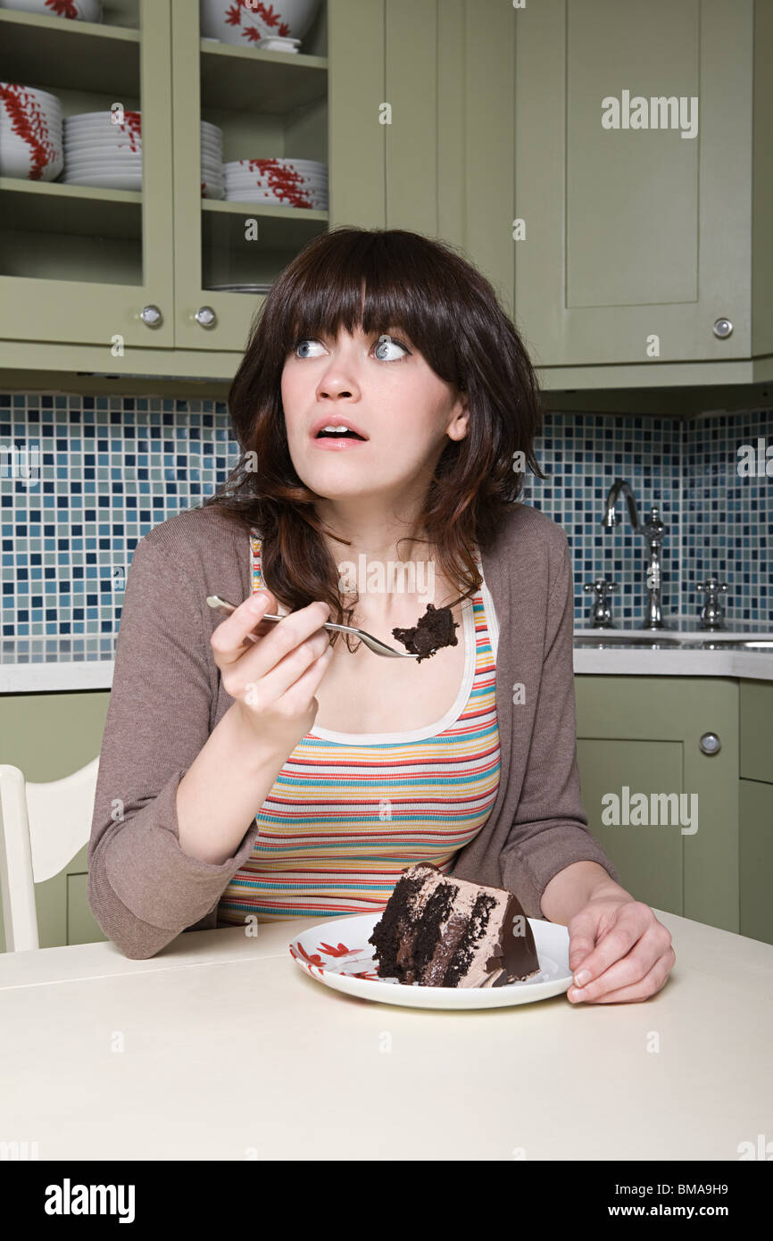Young woman eating chocolate cake Stock Photo Alamy