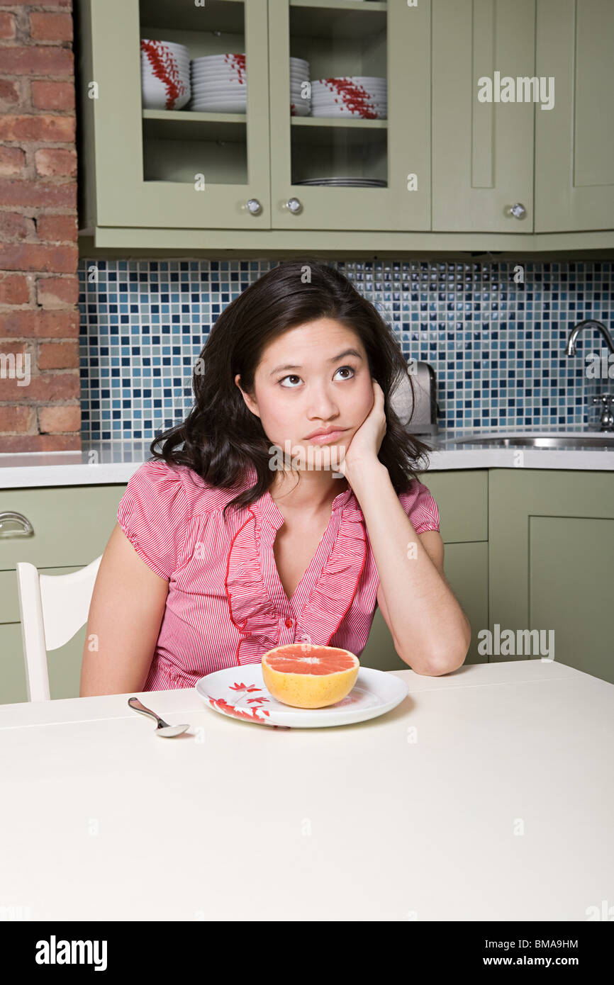 Young woman eating grapefruit Stock Photo Alamy