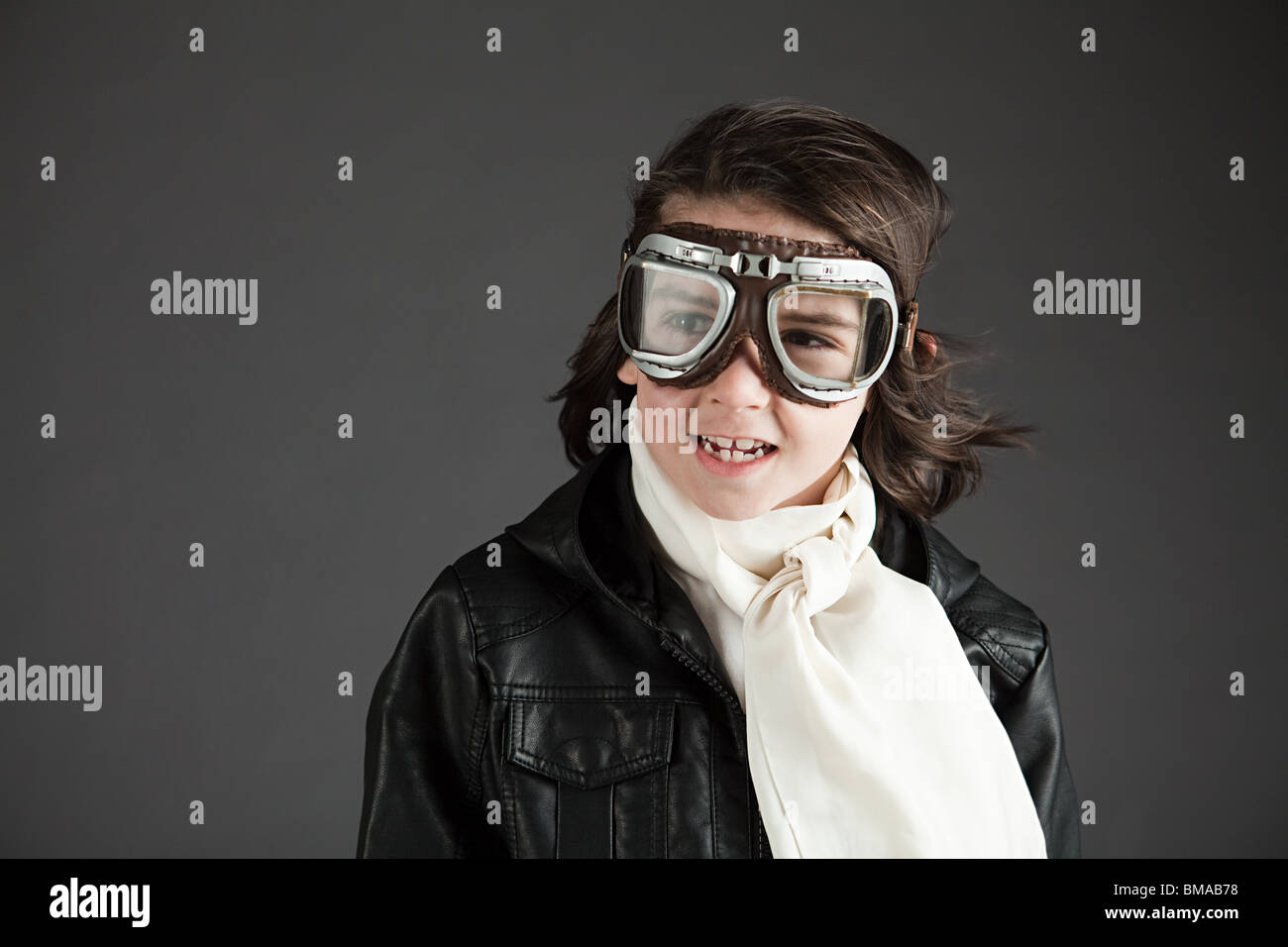 Young boy wearing flying goggles, dressed as pilot Stock Photo