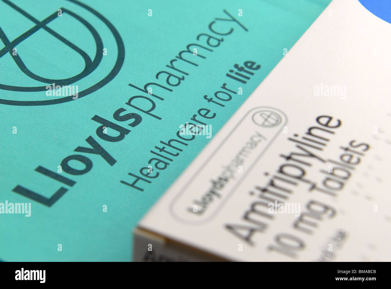 generic Lloyds Pharmacy image.  shows paper prescription bag plus strip of pills or tablets Amitriptyline nerve pain depression Stock Photo