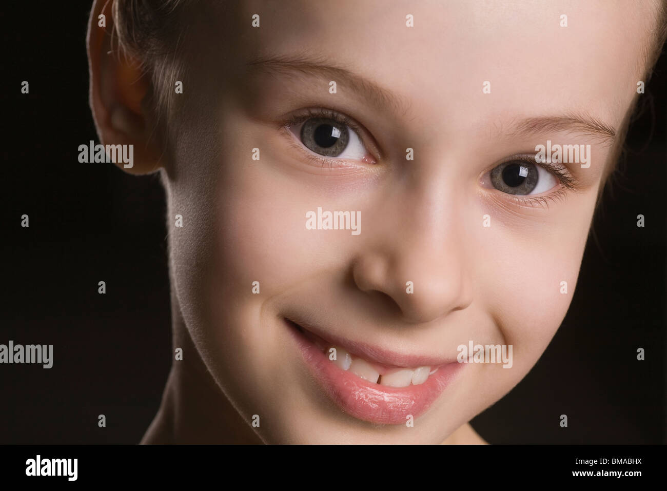 Young girl smiling at camera Stock Photo - Alamy