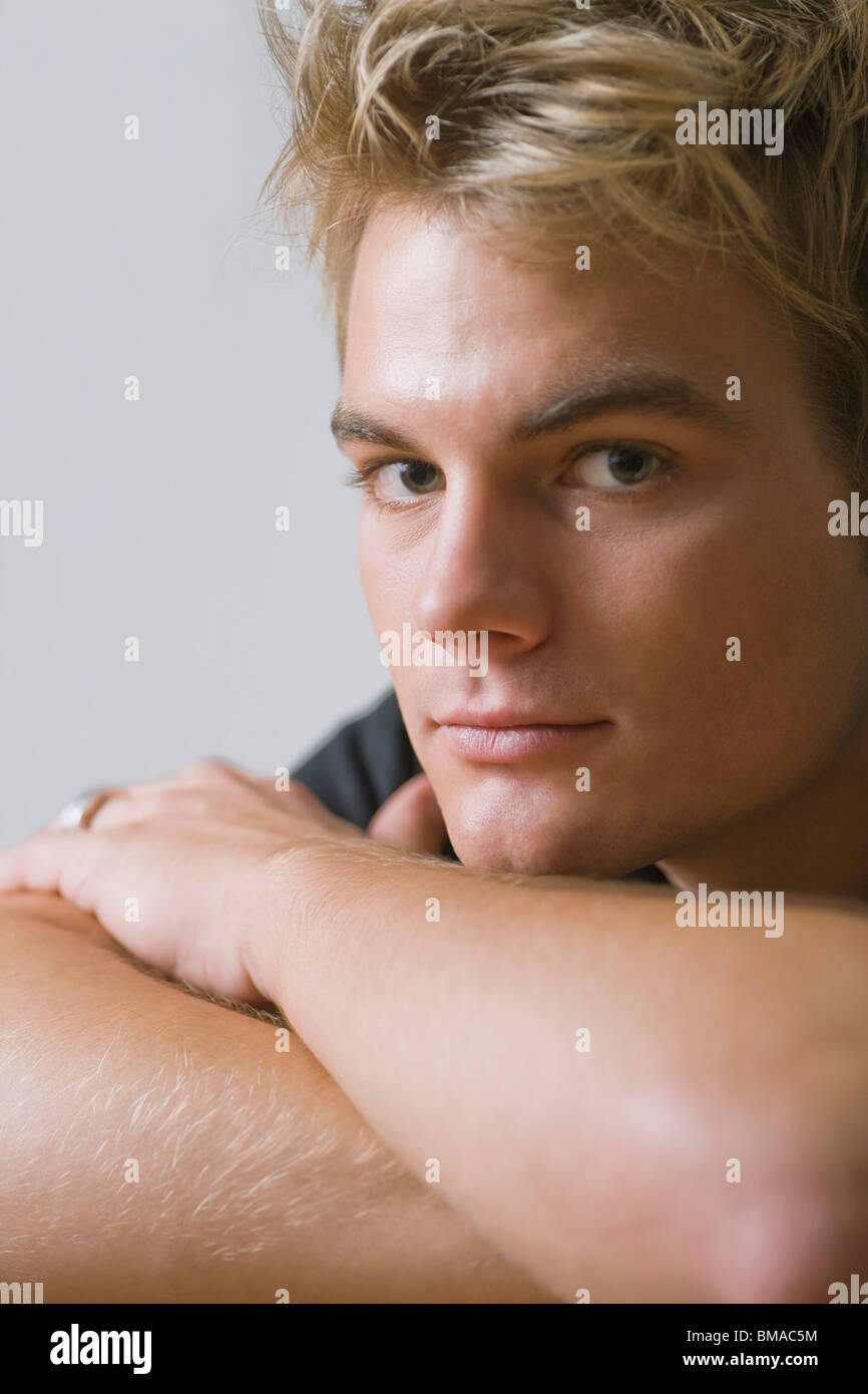 Portrait of Man with Chin Resting on Arms Stock Photo