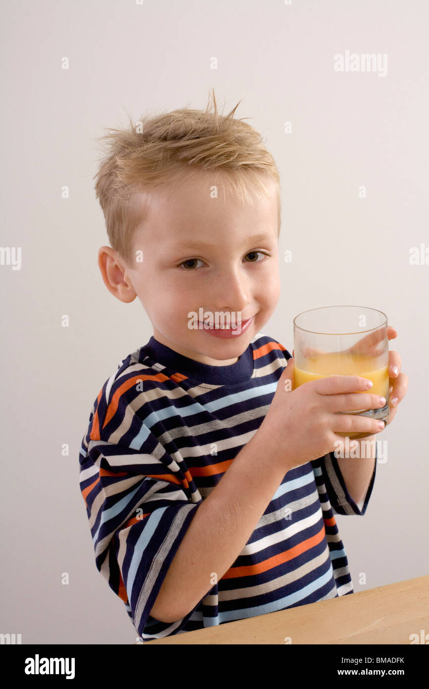 Boy Drinking Orange Juice Stock Photo Alamy