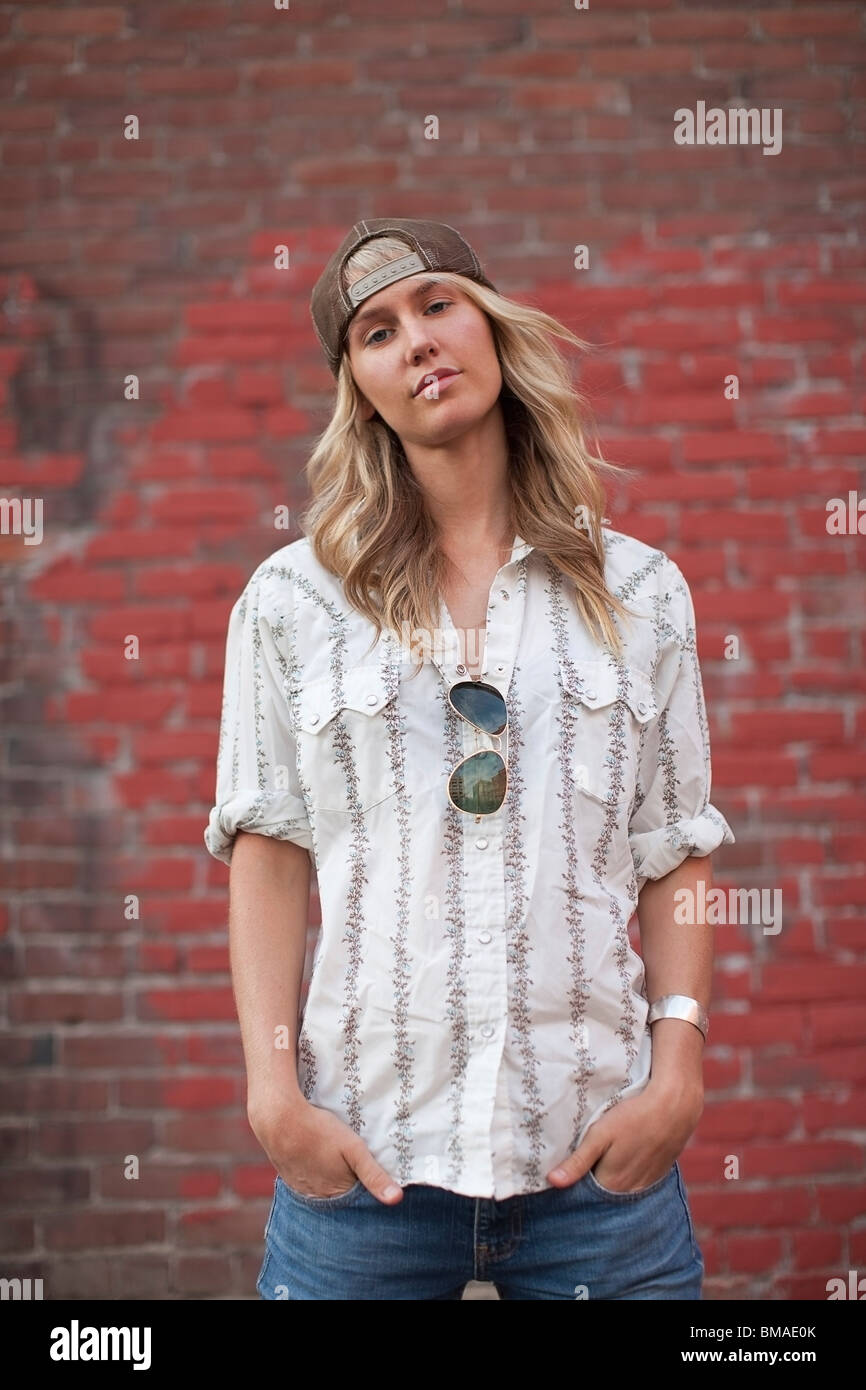 Portrait of Woman Standing in Front of Brick Wall Stock Photo - Alamy