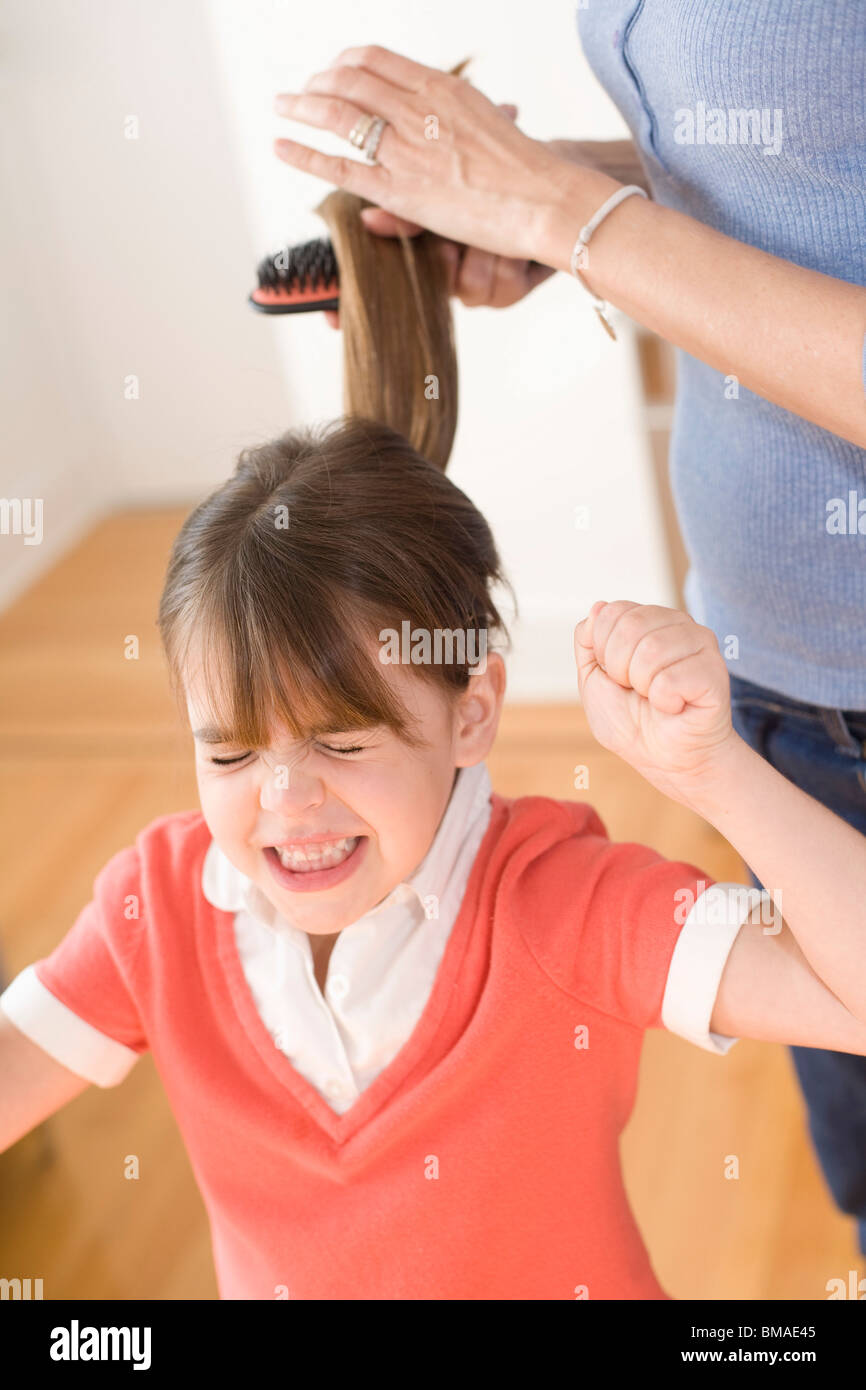 Girl Unhappy with having Hair Brushed Stock Photo