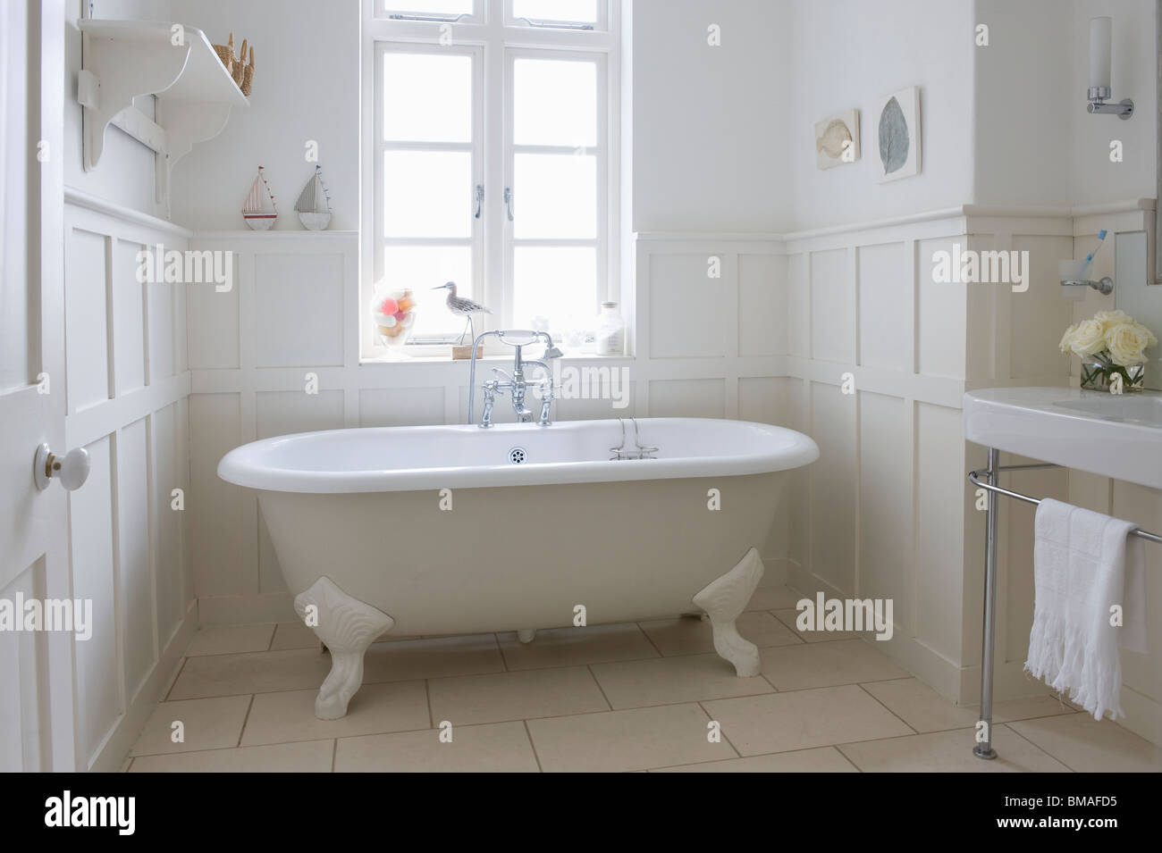 Freestanding roll top in panelled bathroom, London Stock Photo