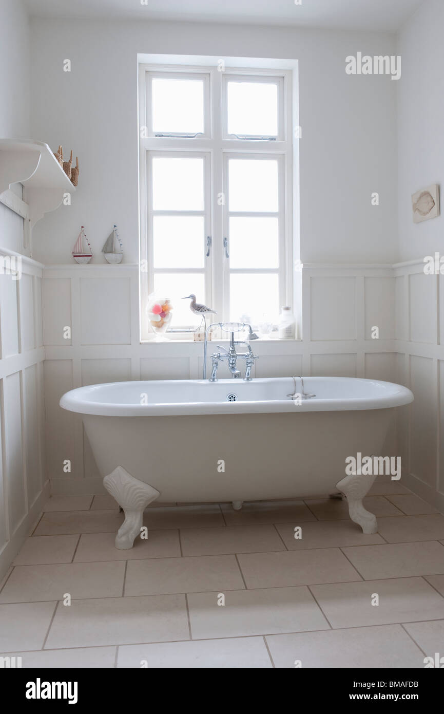 Freestanding roll top in panelled bathroom, London Stock Photo