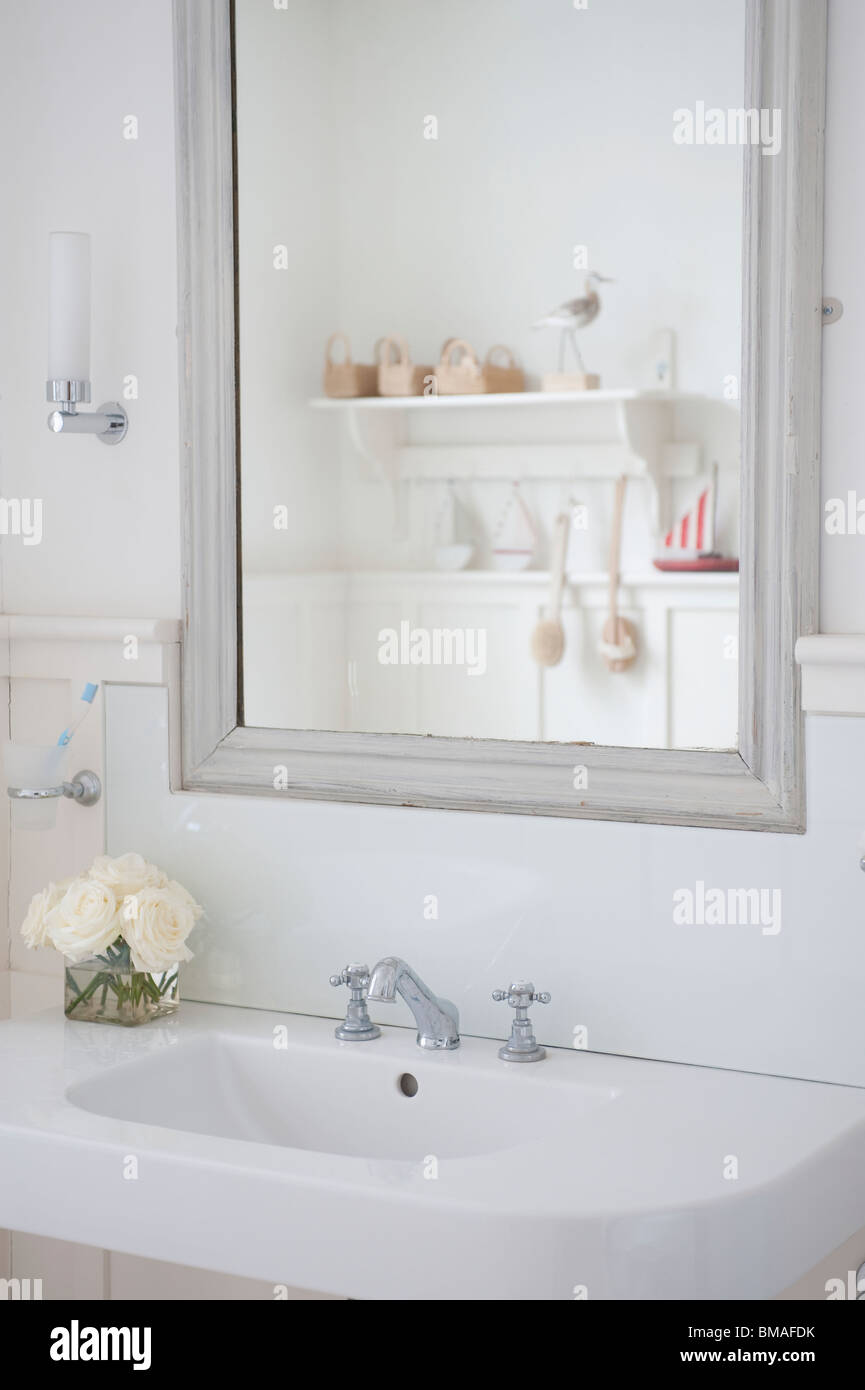 Grey painted mirror surround above washbasin, London Stock Photo Alamy