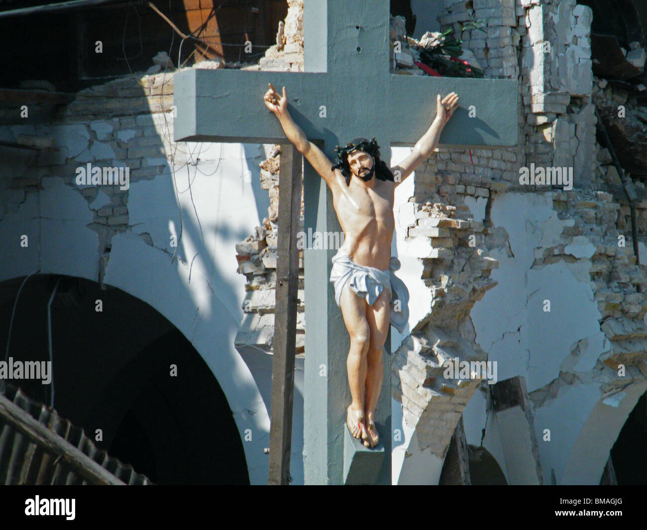 Jesus on the cross in front of the collapsed Sacre Coeur church in Port au Prince after the Haiti earthquake Stock Photo